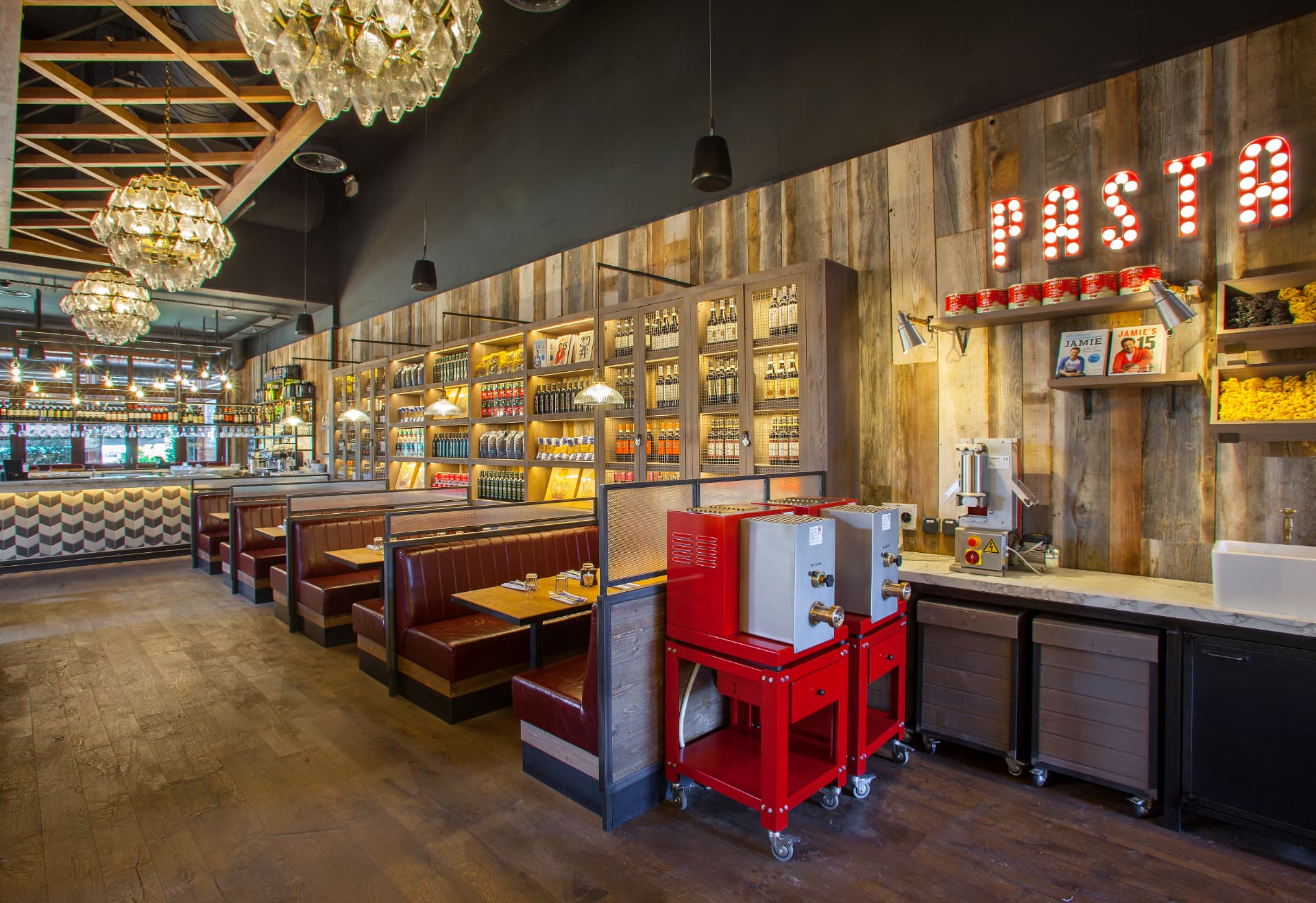 Dining hall with pasta station, marquee signage and glass chandeliers