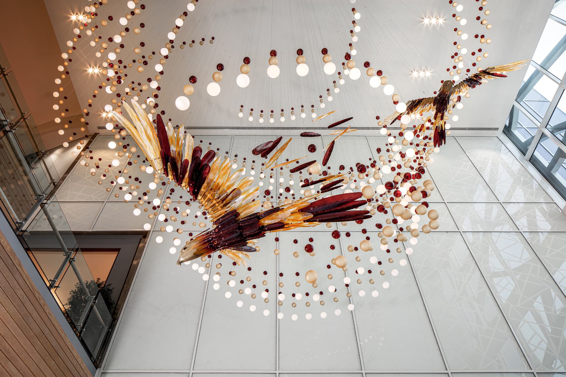 Overhead view of the glass falcon installation and hanging light spheres