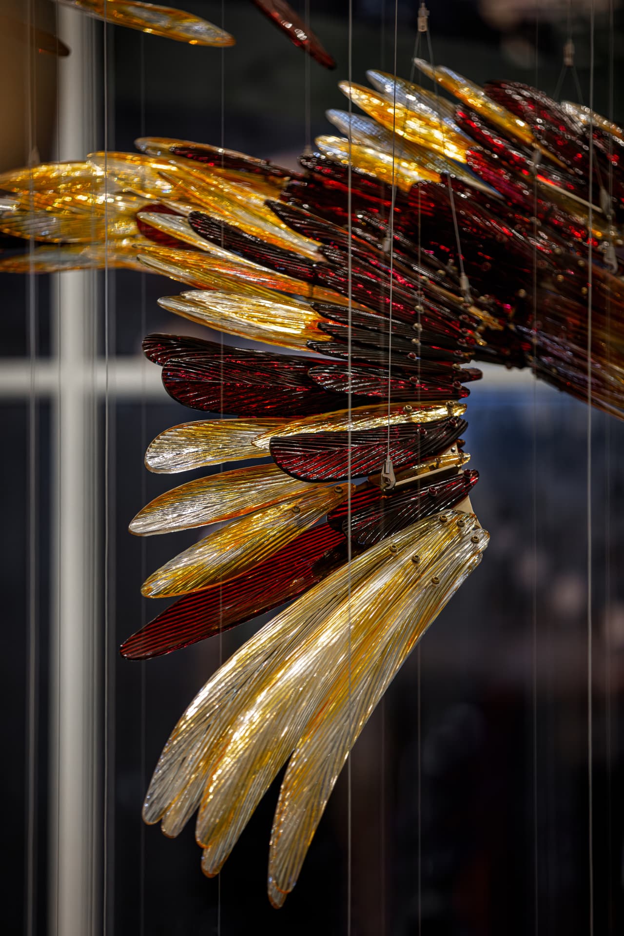 Detail of hand-blown amber and ruby glass feathers