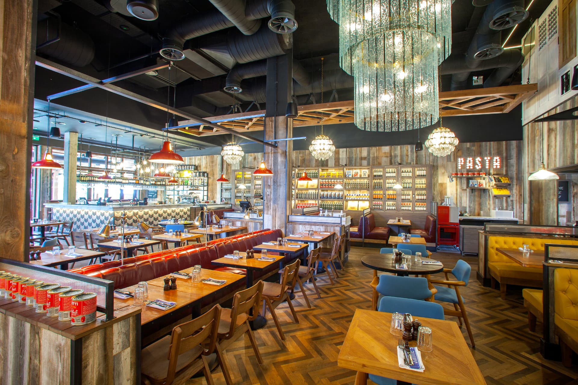 Main dining room with reclaimed timber walls and bar beyond