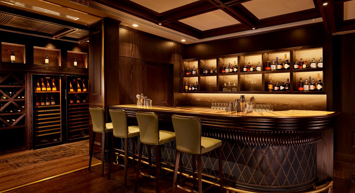 Panelled bar with brass detailing and parquet flooring